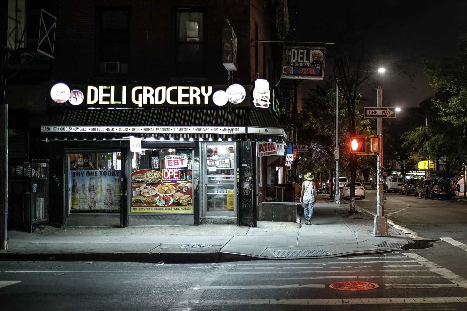 Deli Grocery near road at night time